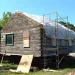Placing a tarp to protect the building